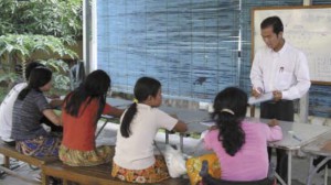 Leng Sophea gives a Khmer lesson to young women who have had reconstructive hand surgery.